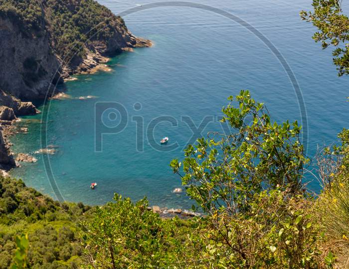 Italy, Cinque Terre, Corniglia, A Large Body Of Water Surrounded By Trees