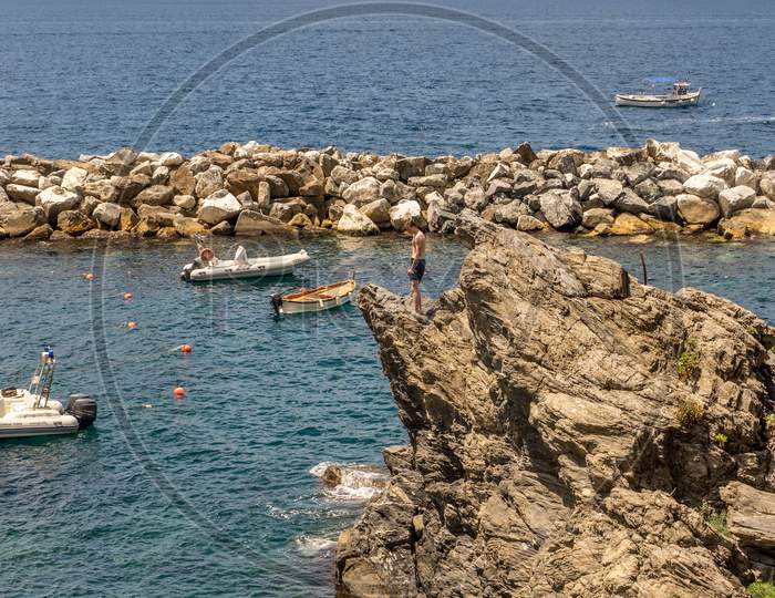 Manarola, Cinque Terre, Italy - 26 June 2018: Tourists Enjoying The Beach And Sunshine At Manarola, Cinque Terre, Italy