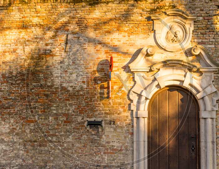 Belgium, Bruges, A Close Up Of A Stone Wall With Door