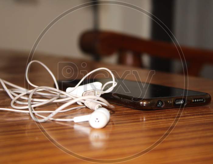 Earphone and phone on table