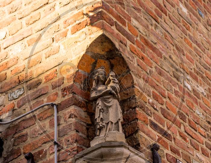 Belgium, Bruges, A Close Up Of A Brick Building With Sculpture Of Madonna And Baby Christ