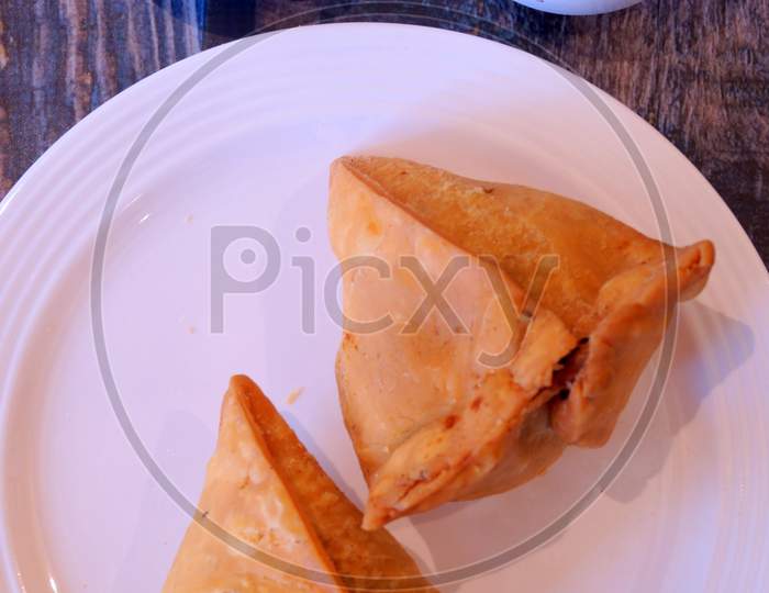 Samosa with red and green chutney.