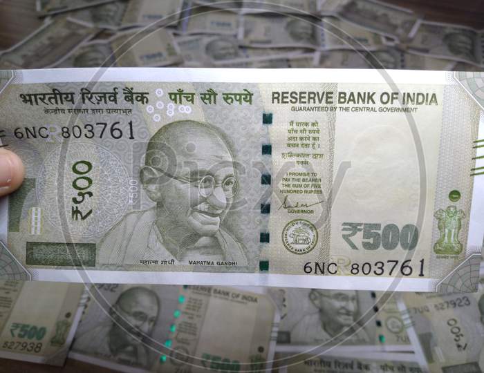 Indian Currency,New 500 Rupee Note In Hand With Blury Background