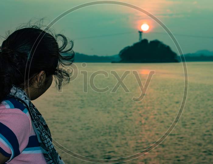 Girl Posing At Ship Deck With Sunset Orange Sky