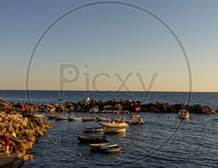 Riomaggiore, Cinque Terre, Italy - 26 June 2018: Boats And Yachts On The Ocean During Sunset, Italian Riviera Of Riomaggiore, Cinque Terre, Italy