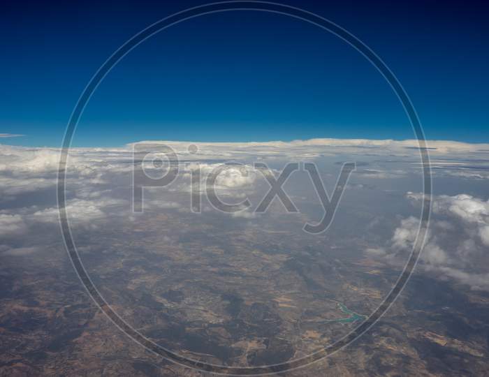 The Land On Earth Viewed From Aeroplane In Sky With Clouds, Spain