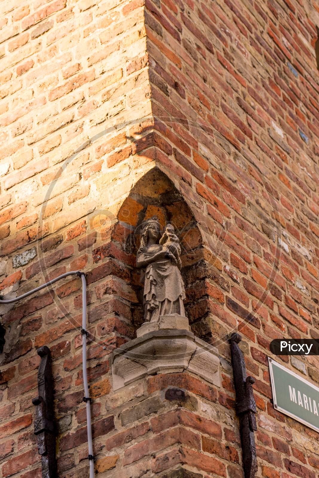 Belgium, Bruges, A Close Up Of A Brick Building With Sculpture Of Madonna And Baby Christ