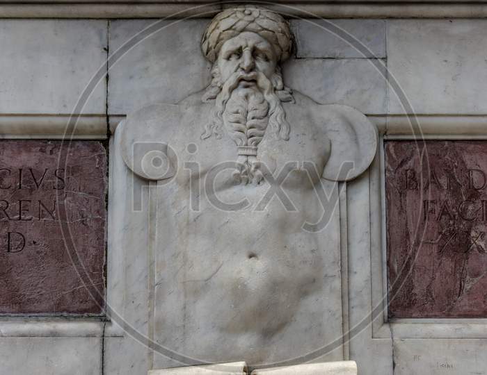 Italy,Florence, A Statue On The Side Of A Building
