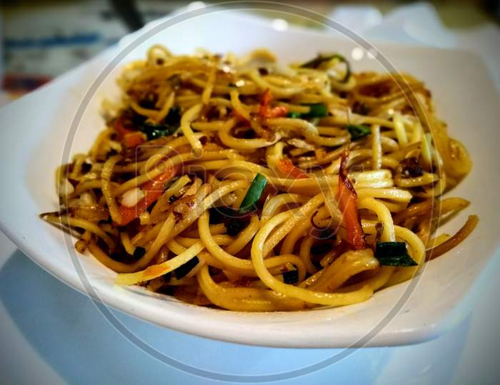 Pan fried noodles with vegatables in a white bowl
