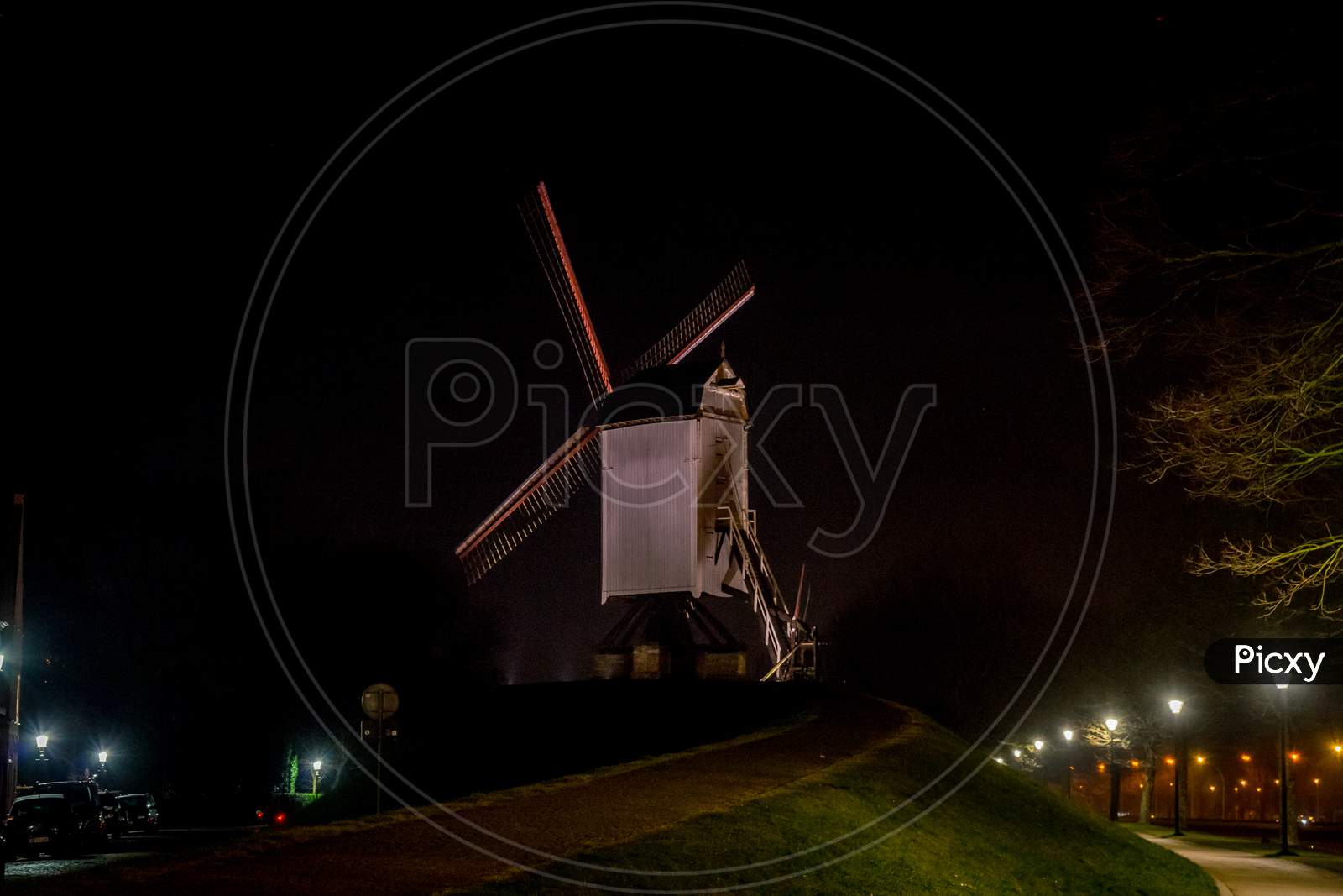 Belgium, Bruges, A Windmill Tower Lit Up At Night