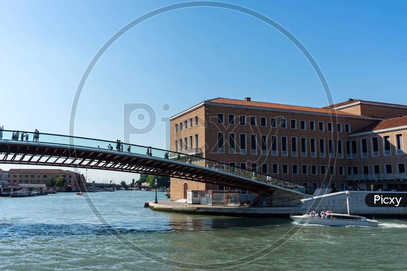People Walking On The Bridge Over The Grand Canal In Venice, Italy