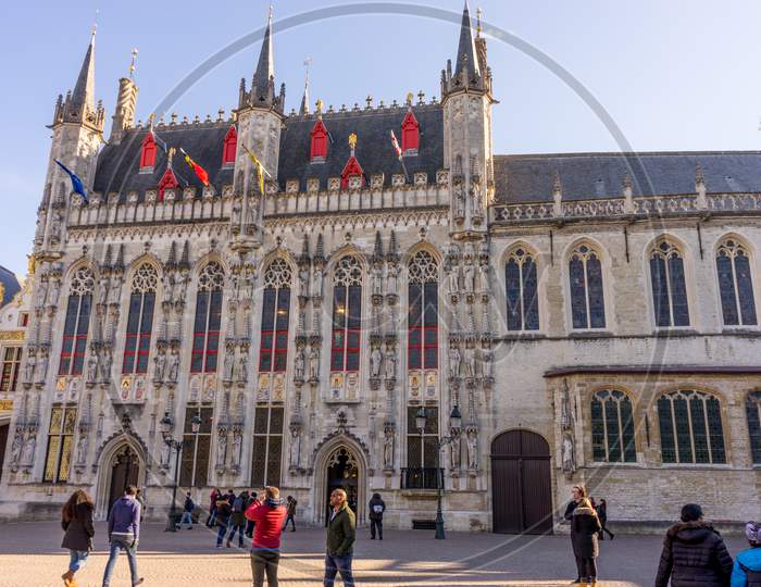 Bruges, Belgium - 17 February 2018: People Walk In Front Of The City Square In Bruges, Belgium