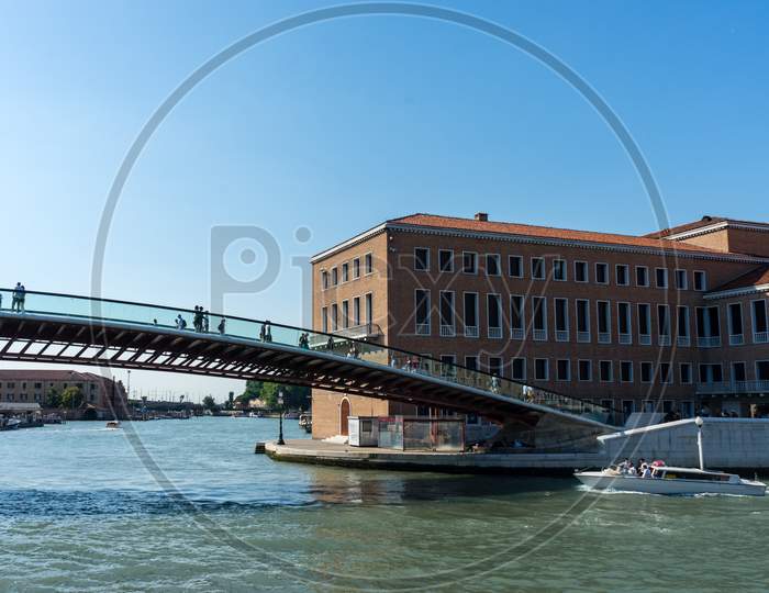 People Walking On The Bridge Over The Grand Canal In Venice, Italy