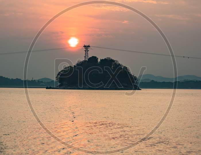 Sunset Orange Sky With River Island Backdrop At Dusk