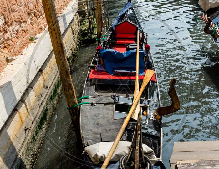 The Gondolas Parked Near Bridge In Venice, Italy