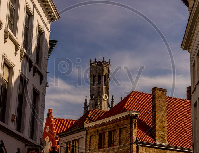 Belgium, Bruges, A Large Bellfry Tower Towering Over A City