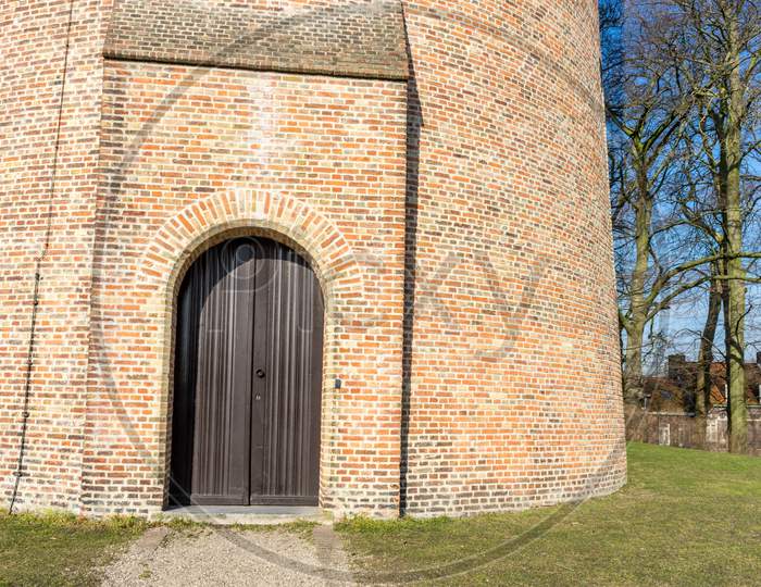Belgium, Bruges, Wooden Door Against Red Brick Building