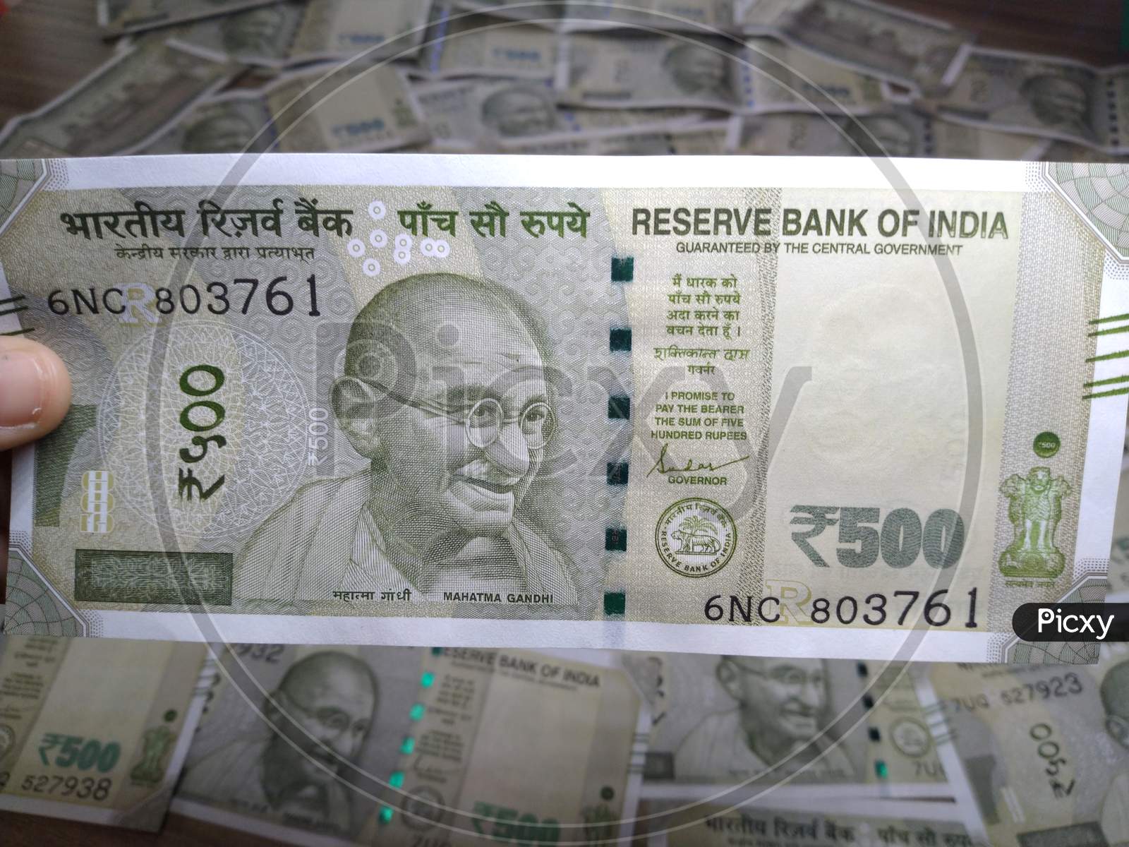 Indian Currency,New 500 Rupee Note In Hand With Blury Background