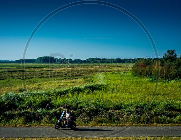 Netherlands, South Holland - 22July 2018: A Person Riding A Bike Down A Dirt Road
