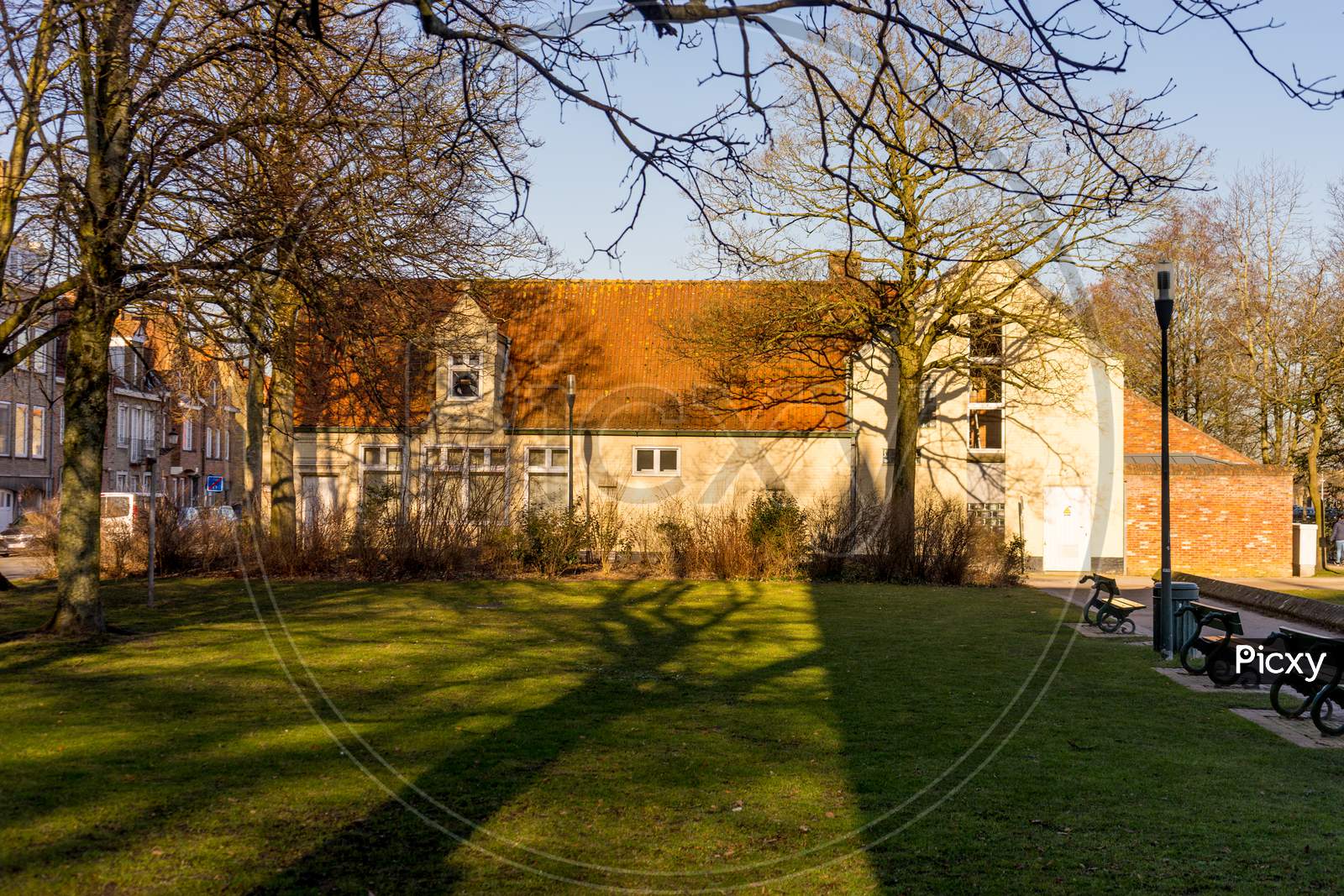 Bruges, Belgium - 17 February 2018:Grass Lawn In Front Of A Cozy Cottage