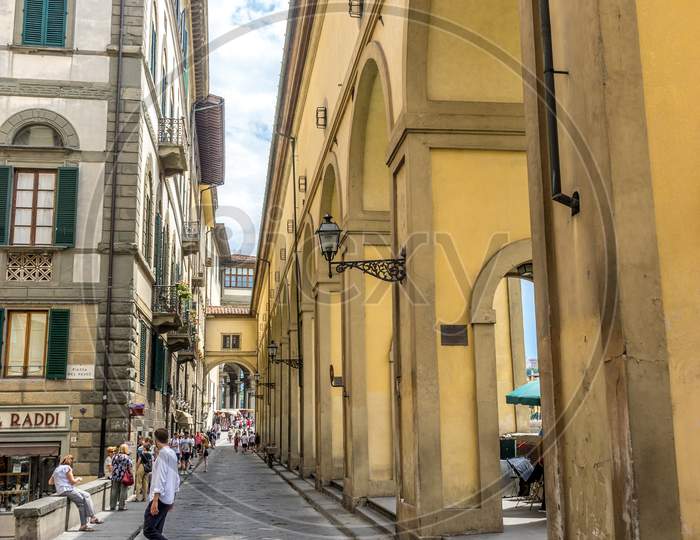 Florence, Italy - 25 June 2018: Tourists On The Narrow Cobblestone Street In Florence, Italy