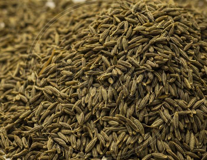 Cumin seeds or caraway seeds. Surface covered with cumin seeds.