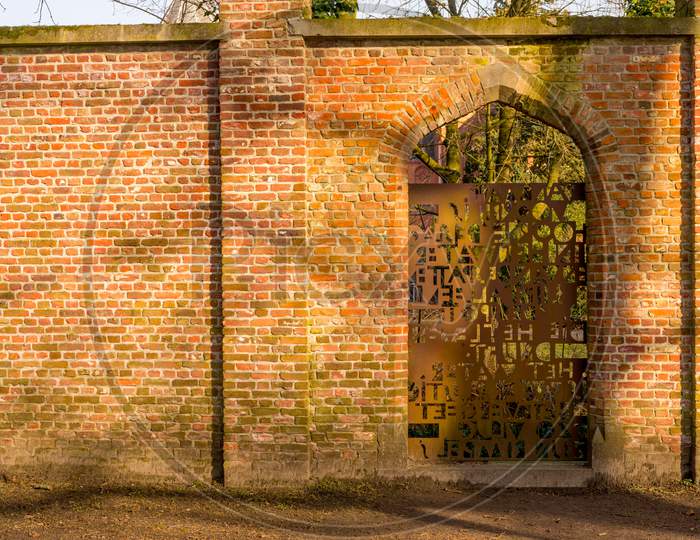 Belgium, Bruges, Steel Door With Red Brick Wall