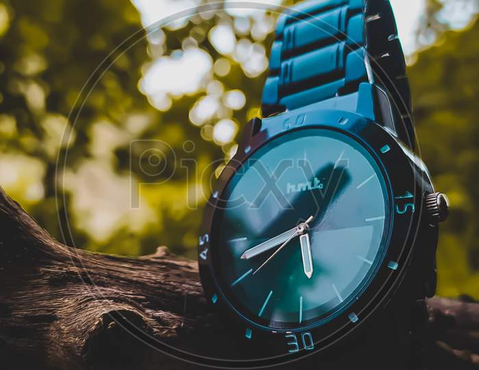 A watch showing time with natures beauty