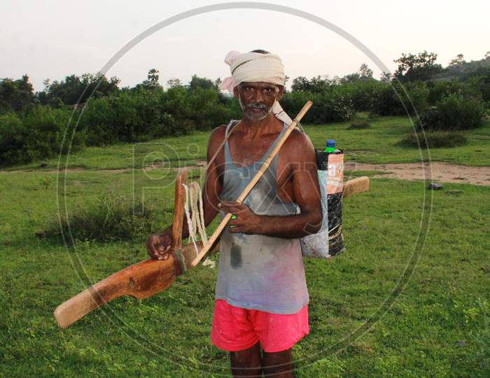 A Indian farmer with his farming tool, farmer going home after plowing the field