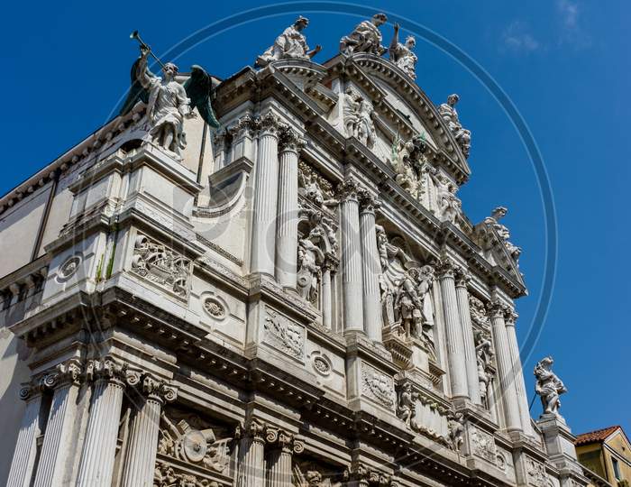 Italy, Venice, A Large Stone Statue In Front Of A Building