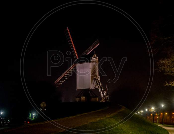 Belgium, Bruges, A Windmill Tower Lit Up At Night
