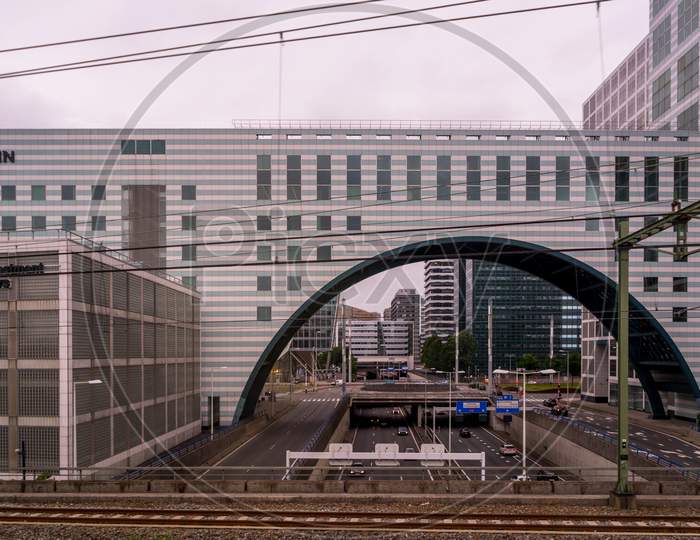 Den Haag, 22 June 2018: The Nn Investment Partners Building With An Arch And Road Below Viewed From Den Haag Central Railway Station