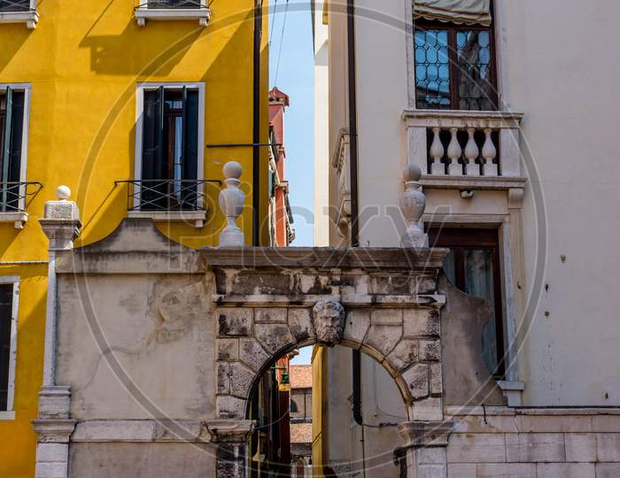 Italy, Venice, A Stone Church With A Clock On The Side Of A Building