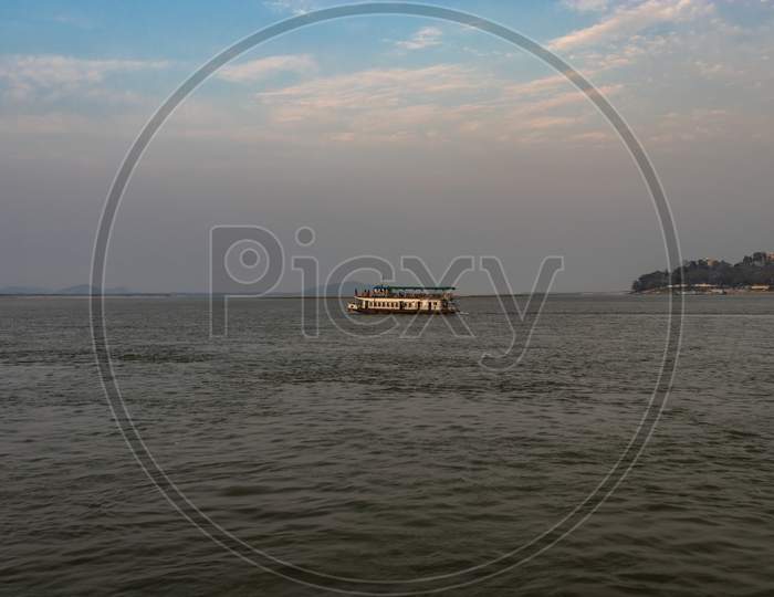 Ship Heading Towards River Island At Dusk