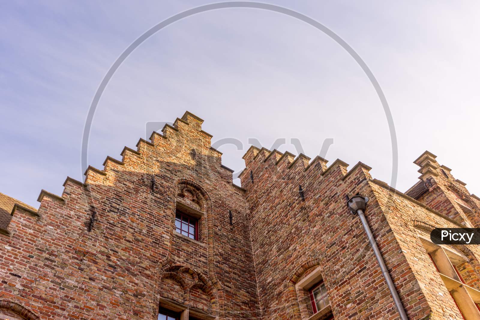 Belgium, Bruges, A Gable On Top Of Large Brick Building