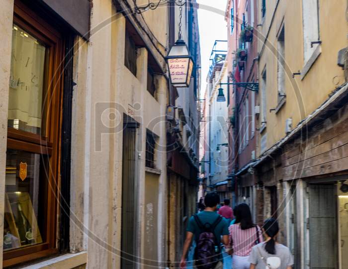 Venice, Italy - 30 June 2018: People Walking Down The Narrow Streets Of Venice, Italy