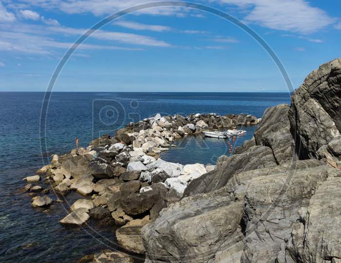Italy,Cinque Terre,Riomaggiore, A Rocky Beach Next To The Ocean