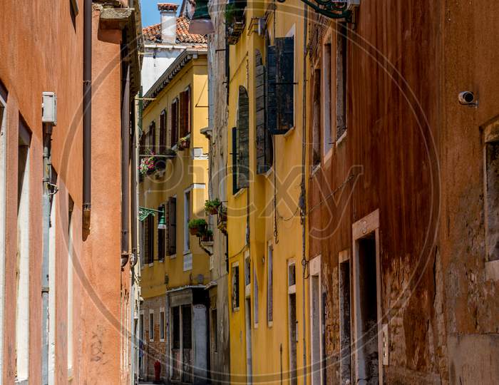 Italy, Venice, A Narrow Street In Front Of A Brick Building