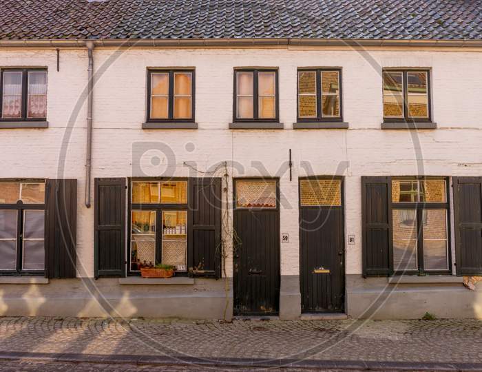 Belgium, Bruges, A House That Has A Sign On The Side Of A Building