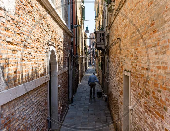 Italy, Venice, A Stone Building That Has A Narrow Street