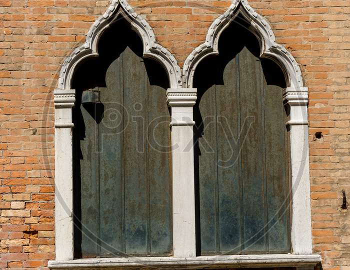 Italy, Venice, A Large Brick Building With Many Windows