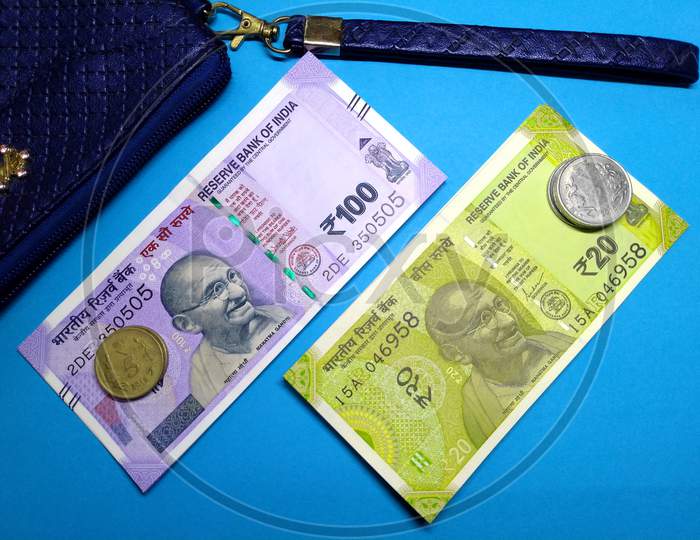 Indian Currency ,100,20 Rupee Notes With Purse With Blue Background