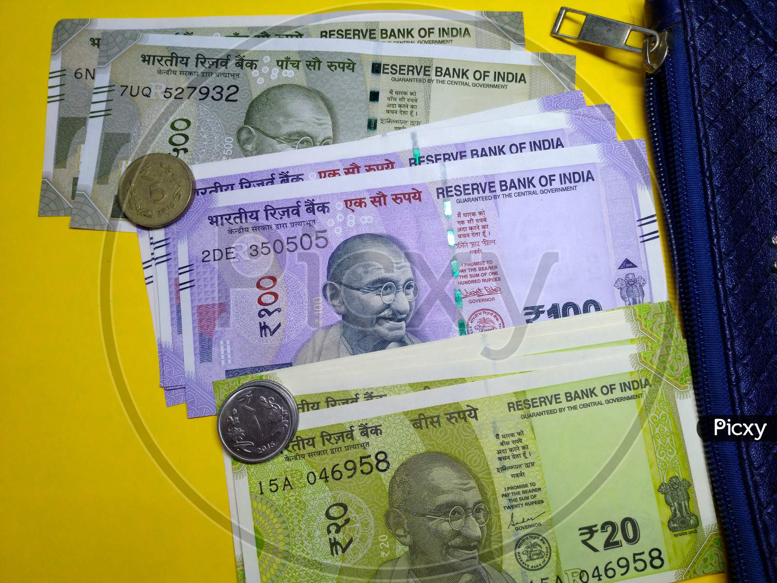 Indian Currency ,500,100,20 Rupee Notes With Purse With Yellow Background.