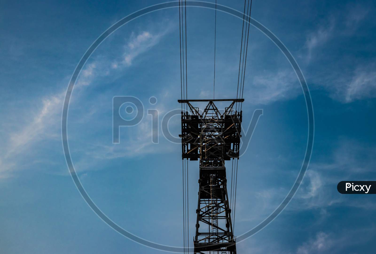 Electric Power Transmission Line With Bright Blue Sky Background
