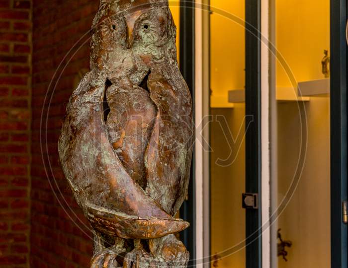 Belgium, Bruges, An Owl In Front Of A Door