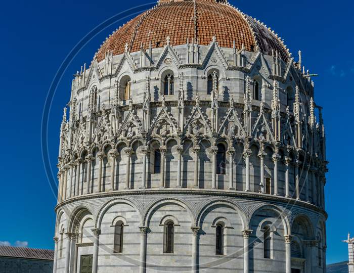 Pisa Baptistery Battistero Di Pisa On Piazza Del Miracoli Duomo Square,Camposanto Cemetery, Leaning Tower Of Pisa In Tuscany, Italy