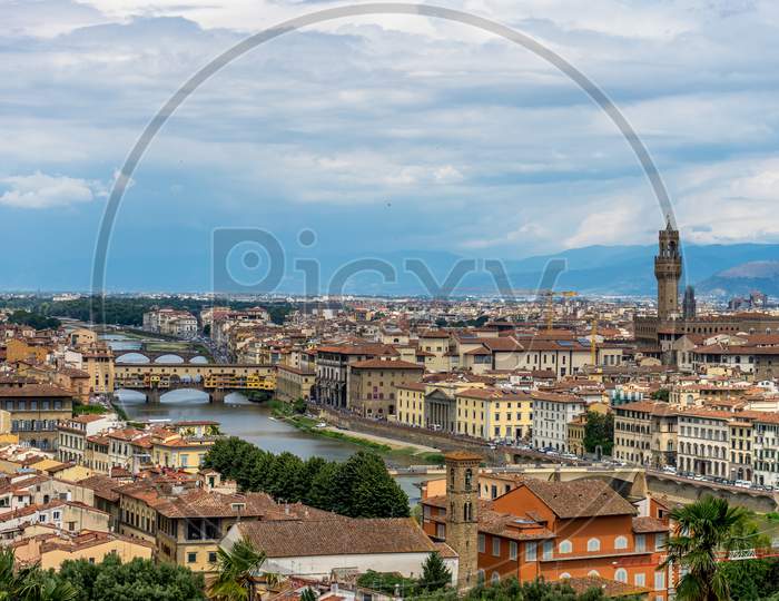 Panaromic View Of Florence Townscape Cityscape Viewed From Piazzale Michelangelo (Michelangelo Square) With Ponte Vecchio And Palazzo Vecchio