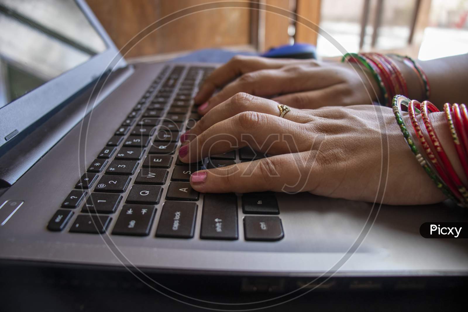 Female Wearing Bangles And Working From Home.
