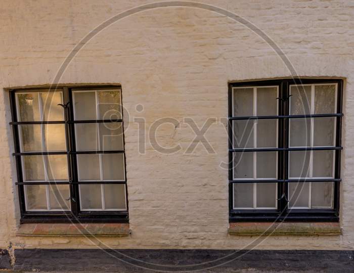 Belgium, Bruges, A Glass Window Against White Wall