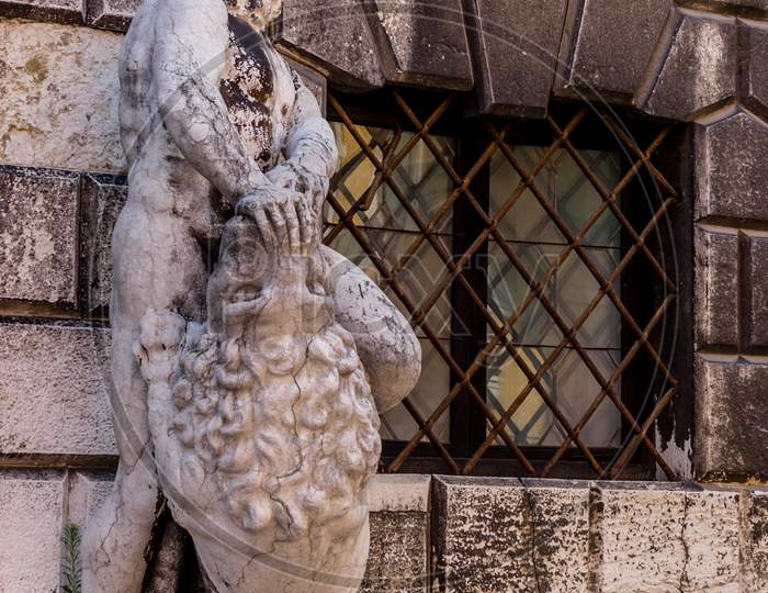 Italy, Venice, A Statue In Front Of A Brick Building